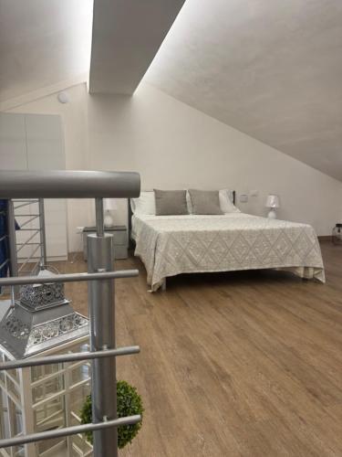 a bedroom with a bed and a wooden floor at Sole di Sicilia in Locogrande