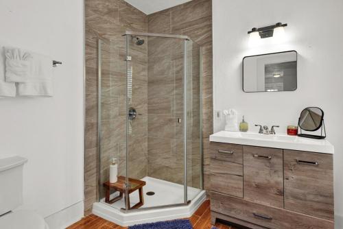 a bathroom with a shower and a sink at Cedar Street Retreat - Unit C in St. Augustine