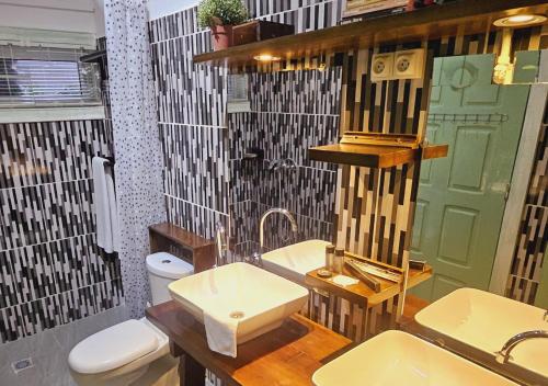 a bathroom with a sink and a toilet at Retreat Cameroon BASTOS in Yaoundé