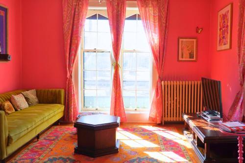 a living room with a couch and a window at The Sanctuary on Washington in Norwich