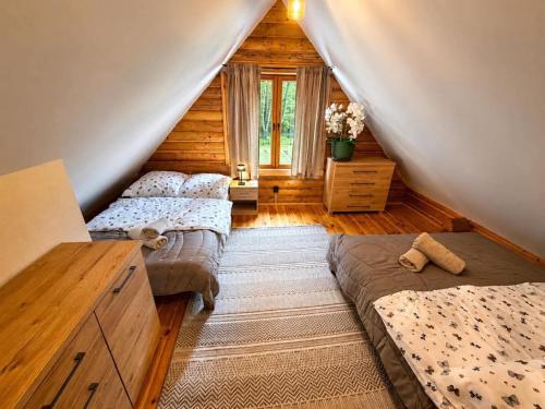 a bedroom with two beds in a attic at Radawski Chill in Radawa