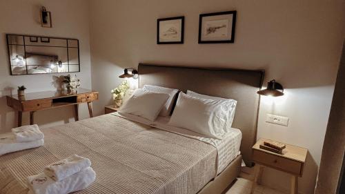 a bedroom with a bed with two towels on it at Abela Family Hotel in Argassi