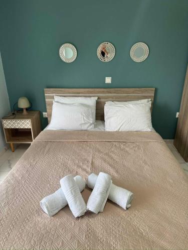 a bed with two pillows on top of it at VALANTIS APARTMENT in Kavála