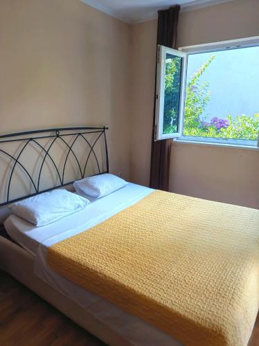 a bed in a bedroom with a window at Riviera Budva Residence in Budva