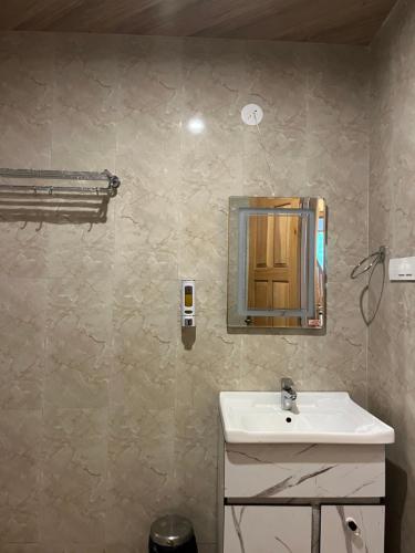 a bathroom with a sink and a mirror on the wall at MK Resort in Palchān