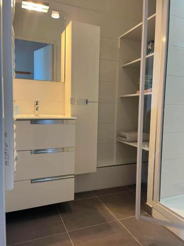 a bathroom with a sink and a mirror at logement de charme vue mer in Binic