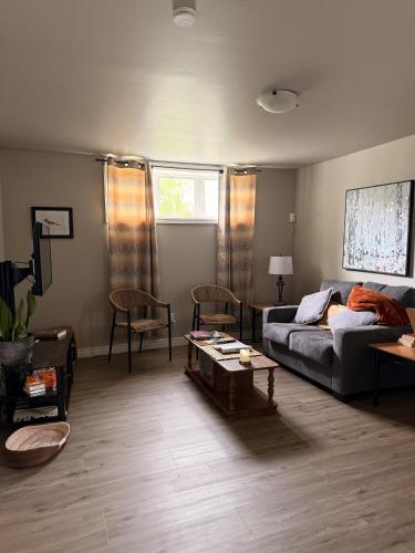 a living room with a couch and a table at Eastpoint Cozy Apartment in St. John's