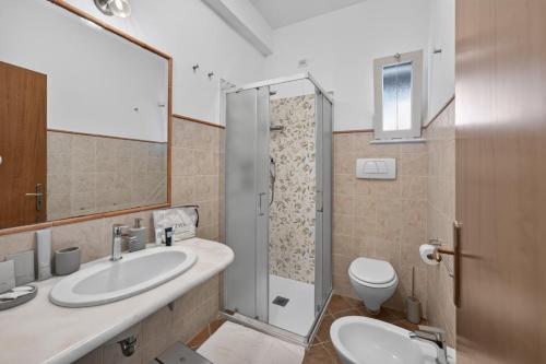 a bathroom with a sink and a toilet and a shower at Villevieille in Piano di Sorrento