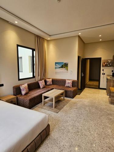 a hotel room with a bed and a couch at Ocean Rooftop Hotel in Ben Slimane