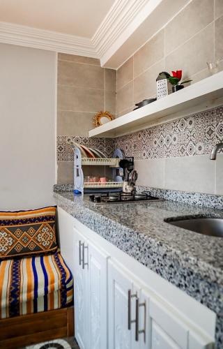 a kitchen with a sink and a counter top at Blue Rina Hostel in Agadir
