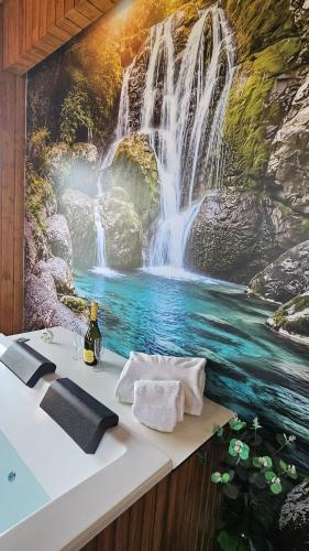 a bathroom with a waterfall mural on the wall at Fernandes Guest House Green Bungalow in Ponte de Lima