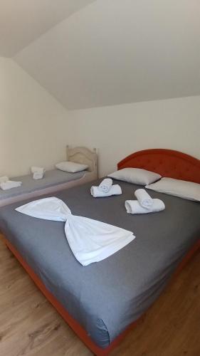 two beds in a room with white towels on them at Vukota - Kuca za odmor in Plav