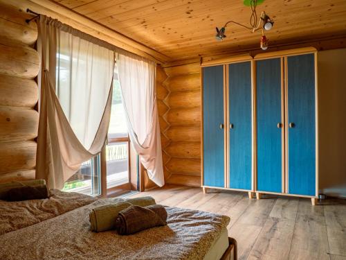 a bedroom with a bed and a large window at Chalet Val d'Or in Nová Baňa