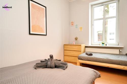 a bedroom with two twin beds and a window at MMRent Divine Room in Gdańsk