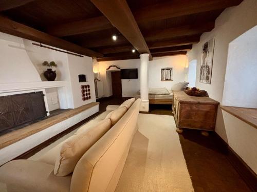a large living room with a couch and a table at Stallrefugium - between lakes, mountains and silence in Seeon-Seebruck