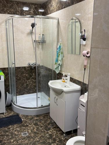 a bathroom with a shower and a sink and a toilet at Dreams House in Yengidzha