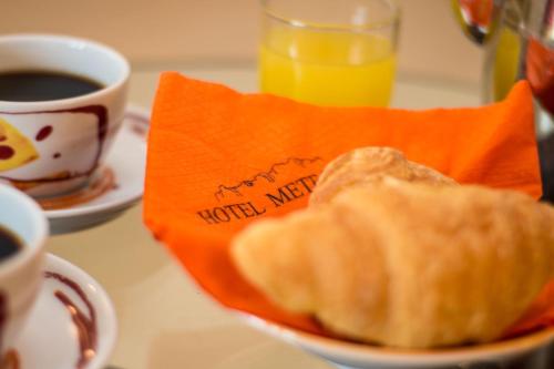 a bowl of bread and coffee and a cup of coffee at Meteora Hotel at Kastraki in Kalabaka