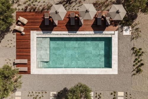 an overhead view of a swimming pool with chairs and umbrellas at Levante Afitos Suites - Adults Only in Afitos