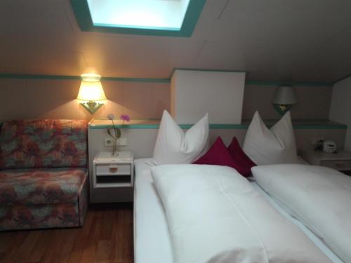 a hotel room with two beds and a couch at Haus Monika in Oetz