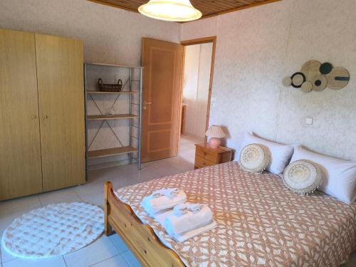 a bedroom with a bed with towels on it at Afroditi Country Residence in Oropos