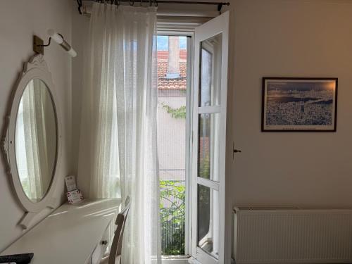 a bathroom with a tub and a large window at Gule Cunda in Ayvalık