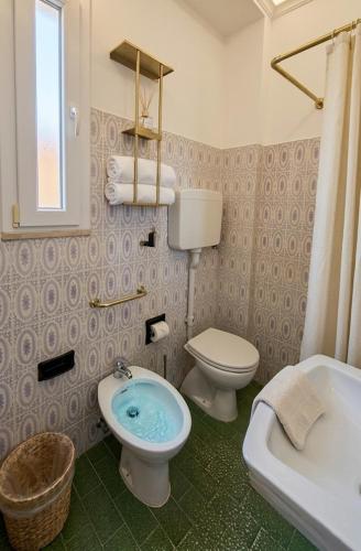 a bathroom with a toilet and a bidet at Hotel Internazionale in Marotta