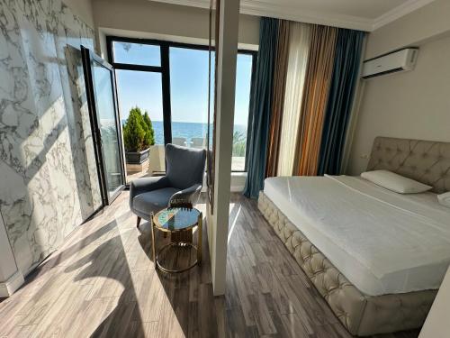a hotel room with a bed and a chair at Villa Marnero in Grigoleti