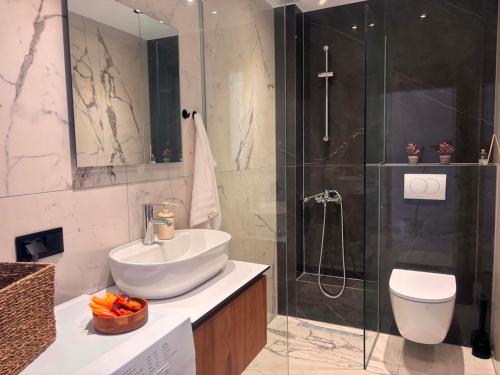 a bathroom with a sink and a shower and a toilet at Linen Sea Halkidiki in Kriopigi