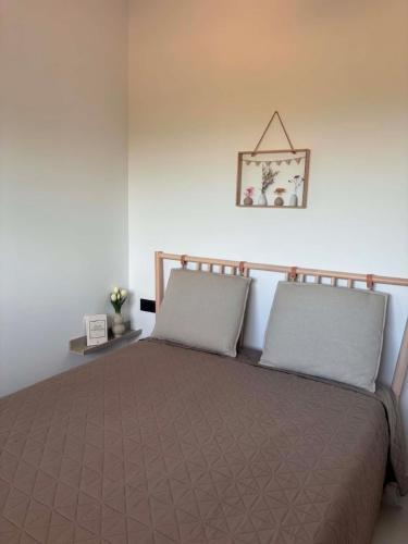 a bedroom with a bed with two pillows on it at Linen Sea Halkidiki in Kriopigi