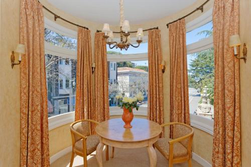 a dining room with a table and chairs and a window at Hotel Sausalito in Sausalito