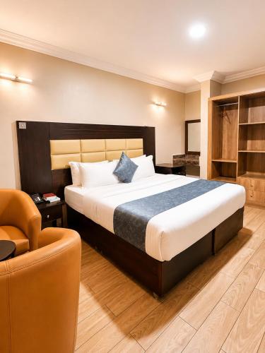 a bedroom with a large bed and a chair at Fadars Place in Sagisa