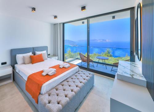 a bedroom with a large bed and a large window at Villa Infinity Sky - Private Pool - Panoramic Sea View in Kaş