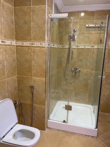 a bathroom with a shower and a toilet at Hôtel Résidence Marrakech in Marrakesh