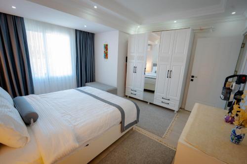 a bedroom with a bed and two white doors at Luna in Dalaman