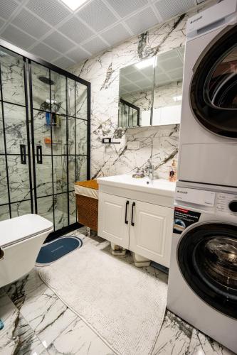a bathroom with a sink and a washing machine at Luna in Dalaman