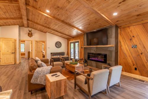 a living room with a couch and a fireplace at Deer Valley in Elk Park