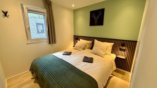 a bedroom with a bed with two pillows on it at Cube & Quiet - Where nature meets comfort in Haarle