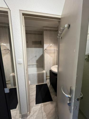 a bathroom with a shower and a tub and a sink at Studio avec piscine à 1km de la plage in Cavalaire-sur-Mer