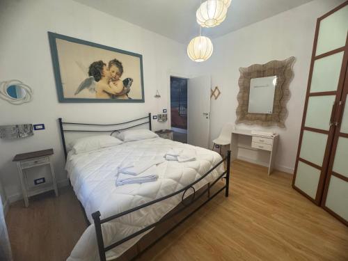 a bedroom with a large bed and a mirror at Casa di Roberta in Passoscuro