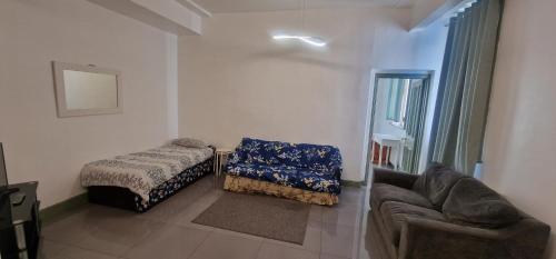 a living room with a bed and a couch at County Studio in Ipswich