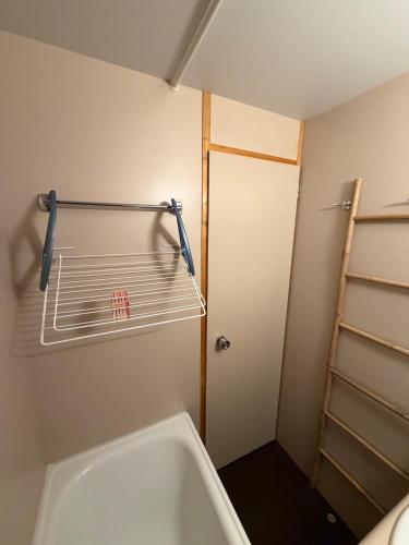 a bathroom with a bath tub and a shelf at Parenthèse nature à Prémanon in Prémanon