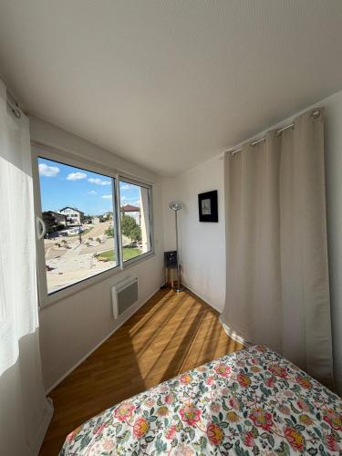 a bedroom with a bed and a large window at Parenthèse nature à Prémanon in Prémanon
