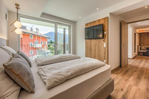 a bedroom with a bed and a large window at Laurena Aparthotel near Brixen in Natz-Schabs