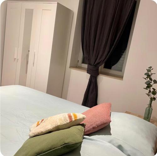 a bedroom with a bed with two pillows on it at La maysou in Ussel