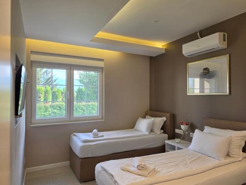 a small room with two beds and a window at Villa Aida in Sarajevo