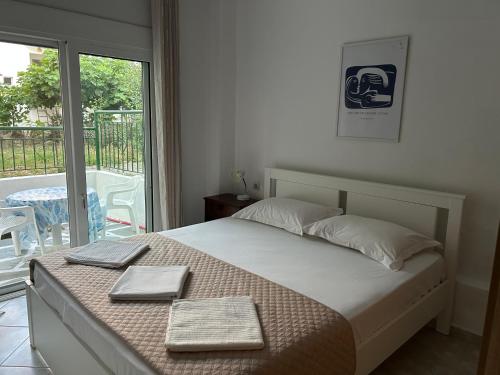 a bedroom with a bed with two towels on it at Evgenias Beach Escape in Kallithea Halkidikis