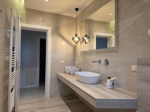 a bathroom with a sink and a mirror at Villa Aida in Sarajevo