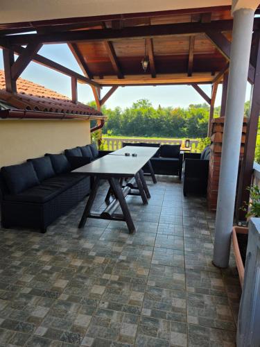 a patio with a couch and a table on a patio at Apartments Šeherzada in Pula