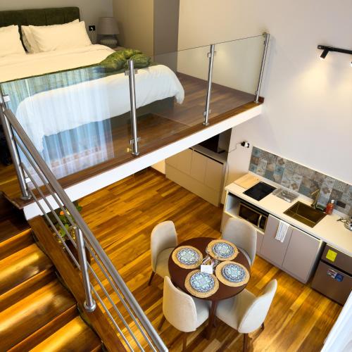 a room with a bunk bed and a table and chairs at Arbórea Casa Boutique in Cuenca