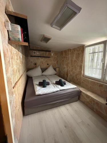 a bedroom with a bed in a small room at Mancs&Buborék Kutyabarát Vendégház in Komló
